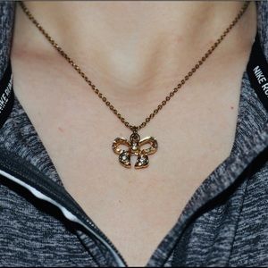 Gold bedazzled bow necklace